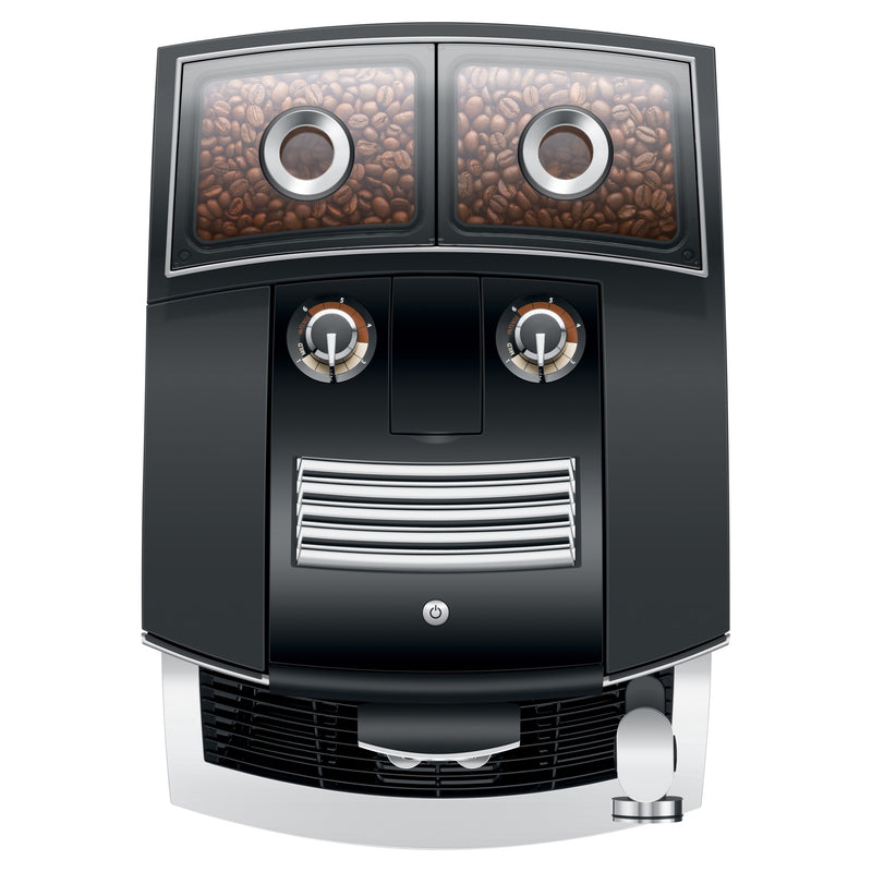 Illustration of the Jura J8 Twin Super Automatic Espresso Machine 15658 Diamond Black viewed from above, with coffee beans visible in the two transparent containers at the top, resembling eyes. Two circular knobs below the containers look like a nose, and a grate below them resembles a mouth. The P.A.G.2+ grinder adds precision to this whimsical design by Jura.