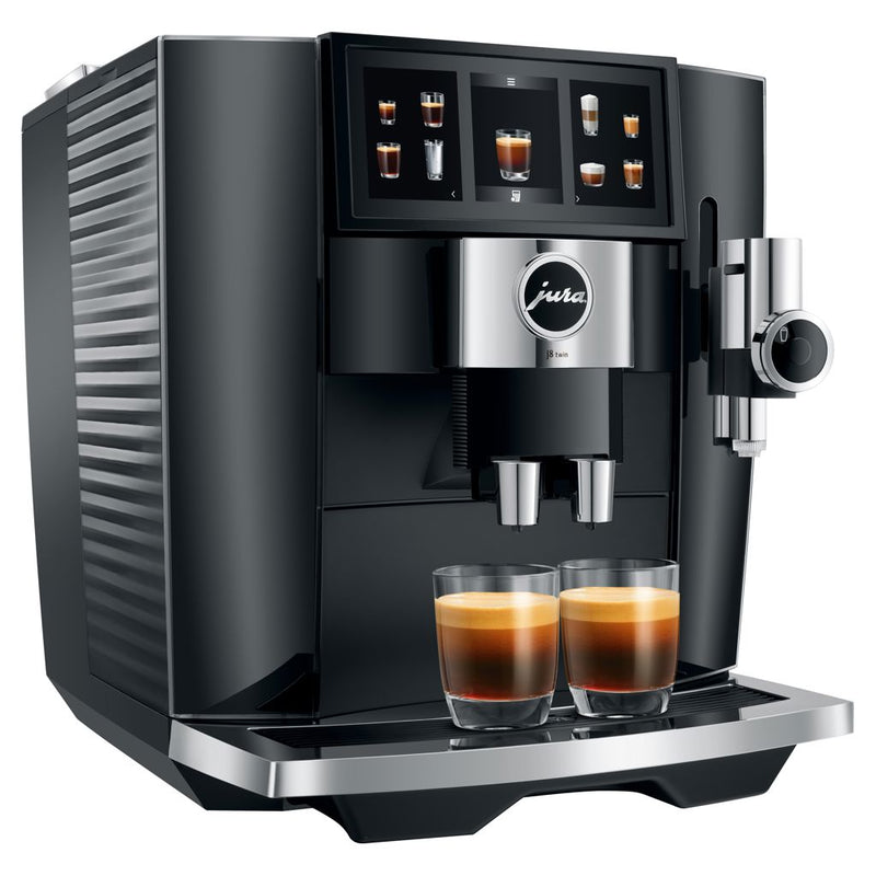 The Jura J8 Twin Super Automatic Espresso Machine 15658 in Diamond Black expertly dispenses two espresso shots into clear glasses with its sleek digital display and selection buttons. Featuring a metallic finish and the Jura logo on the front panel, it also includes the innovative Sweet Foam function for enhanced flavor.