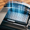 The close-up image displays the Miele Active AirClean filter with TimeStrip SF-AA 50, characterized by its hexagonal pattern accentuated by blue lighting. The Miele control panel reveals various function buttons and indicators, underscoring its efficient design and advanced filtration technology.