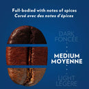 The Lavazza Crema e Gusto K-Cup® Pods' packaging features a coffee bean on a blue background with English and French text: "Full-bodied with notes of spices." Sliced to reveal Dark, Medium, and Light intensities, it's Rainforest Alliance Certified for a rich dark roast experience. Box of 24.