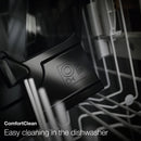 A close-up of a black plastic container labeled "ComfortClean" placed inside a dishwasher. Visible are the rack and other parts of the dishwasher. The text "Easy cleaning in the dishwasher" is displayed at the bottom, perfect for your Miele CM6160 Milk Perfection Countertop Coffee Machine's one-touch programming needs.