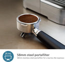 On the countertop, a 58mm stainless steel portafilter with freshly tamped coffee sits in front of the Philips Barista Brew Semi Automatic Espresso Machine PSA3228/01 (Silver), promising barista-quality espresso and accommodating various coffee blends.