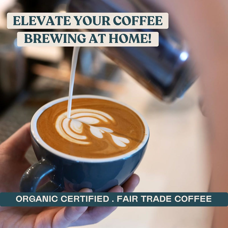 A person pours steamed milk from a metal pitcher into a cup of Equator Coffee Roasters Freakin’ Good Coffee Bean, creating latte art. The image text reads, "Elevate Your Coffee Brewing at Home! Organic Certified. Fair Trade Coffee.