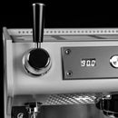 A close-up of the Conti ACE Espresso Machine (Black) highlights its precision in coffee brewing with a display reading "90.0." The elegant machine features a large black handle on the left and a buzzing control panel filled with buttons on the right. The image is presented in striking black and white.