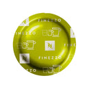 A Nespresso Espresso Finezzo Professional Capsule, part of a box of 50, displays "Finezzo" text and white cup icons against its green surface. This design highlights its circular, smooth shape when viewed from above and suggests the floral aromas of the delightful Arabica blend contained within.