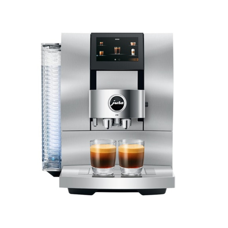 A sleek, aluminum white Jura Z10 Super Automatic Hot Coffee & Espresso Machine is shown with a digital screen on top displaying various coffee options. Below the screen, two freshly brewed espresso shots are positioned side by side, ready to serve. The Swiss engineering ensures precision and quality in every cup.