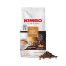 A white bag of Kimbo Crema Intesa Whole Coffee Beans (1kg / 2.2lb) is displayed beside a small pile of beans. The packaging emphasizes features such as "medium dark roast," "intensity 11/13," and "full body with cinnamon notes," and showcases an illustration of a cup of espresso coffee.