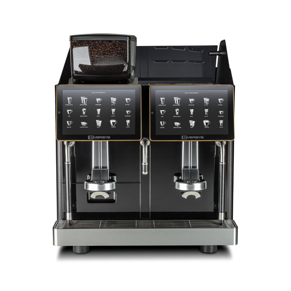 The Eversys Enigma 2 Group Head Steam Wand Super Traditional Espresso Machine E'4s/ST (Charcoal) is a modern espresso machine with a sleek, stainless steel base. It features two dispensers, continuous steam and milk frothing capabilities, and digital displays above the dispensers that showcase various coffee options. The compartment for coffee beans is conveniently located on the top left.