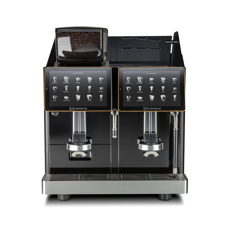 The Eversys Enigma 2 Group Head Milk System Super Traditional Espresso Machine E'4ms/ST (Charcoal) by Eversys is a modern charcoal espresso machine featuring two coffee dispensers and touch screen panels that display various drink options. It includes built-in Electronic Milk Texturing, a grinder with visible coffee beans on the top left, and a sleek metallic base, capable of brewing up to 350 espressos per hour.