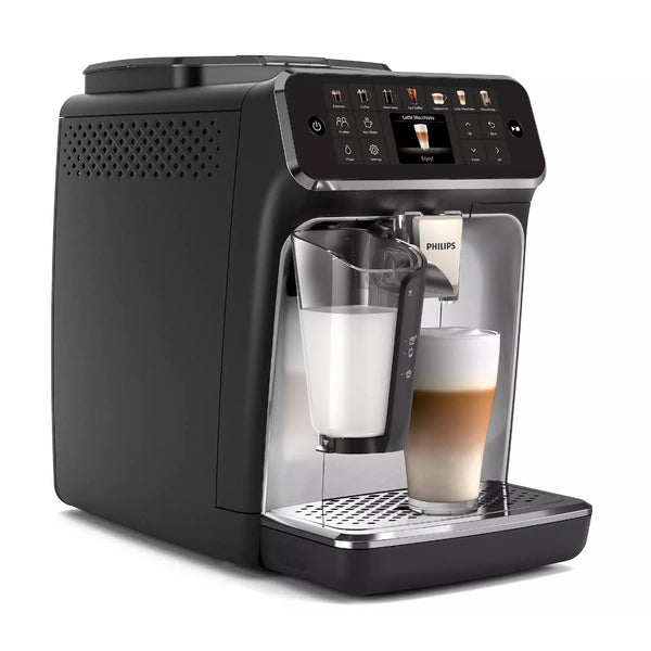 The Philips 4400 LatteGo Super Automatic Espresso, Cappuccino, & Latte Macchiato Machine with SilentBrew EP4447/90 features a sleek black design and touchscreen controls displaying various coffee options. Leveraging SilentBrew technology, this machine makes hot and iced coffee without a sound. The built-in grinder and milk frother enhance the experience, while a glass of layered latte sits on the drip tray with frothy milk pouring from the frother.