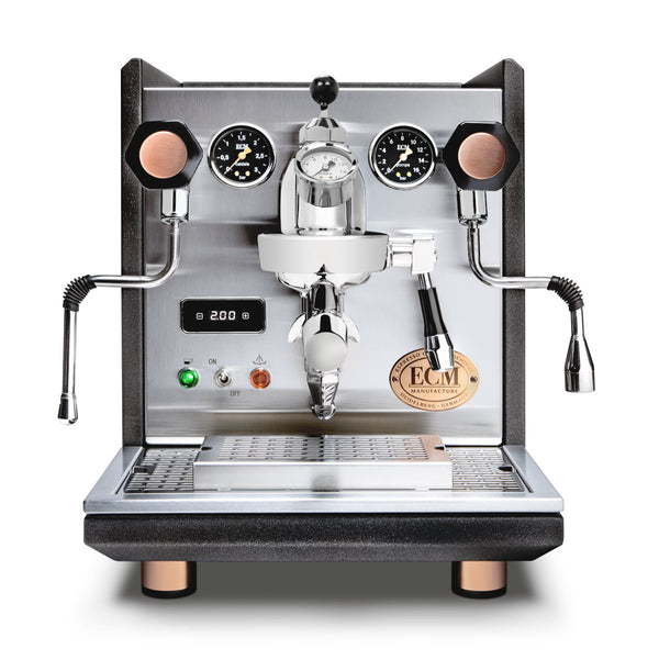 The ECM Synchronika is a stainless steel dual boiler espresso machine featuring PID, flow control, dual pressure gauges, and two steam wands. With central brewing head, digital temperature display, copper accents, and the ECM brand logo on front. Model: Heritage Edition - PREORDER.