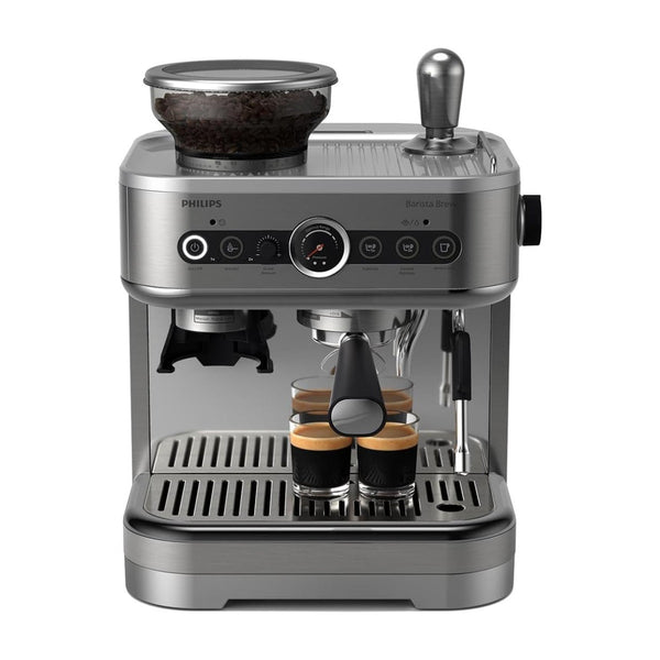 The Philips Barista Brew PSA3218/01 Semi Automatic Espresso Machine features a stainless steel portafilter, built-in grinder, dual bean container, and multiple controls. It brews two espresso cups under the spout with coffee beans visible above.