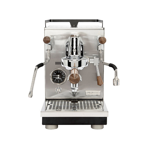 The Profitec Jump Heat Exchanger Espresso Machine, crafted from stainless steel with wooden accents, includes a multifunction switch, pressure gauge, steam wand, and hot water spout. Its discreet display enhances ease of use, while the drip tray is conveniently placed below. The control lever and portafilter are prominently positioned at the center.