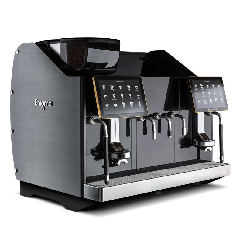 The Eversys Enigma 2 Group Head Milk System Wide Super Traditional Espresso Machine E'4ms x-wide/ST (Charcoal) is a sleek, modern espresso machine that boasts dual coffee dispensers and two interactive digital screens. Its metallic finish, combined with multiple buttons and nozzles for various coffee options, enhances barista productivity while retaining the charm of a traditional espresso machine.