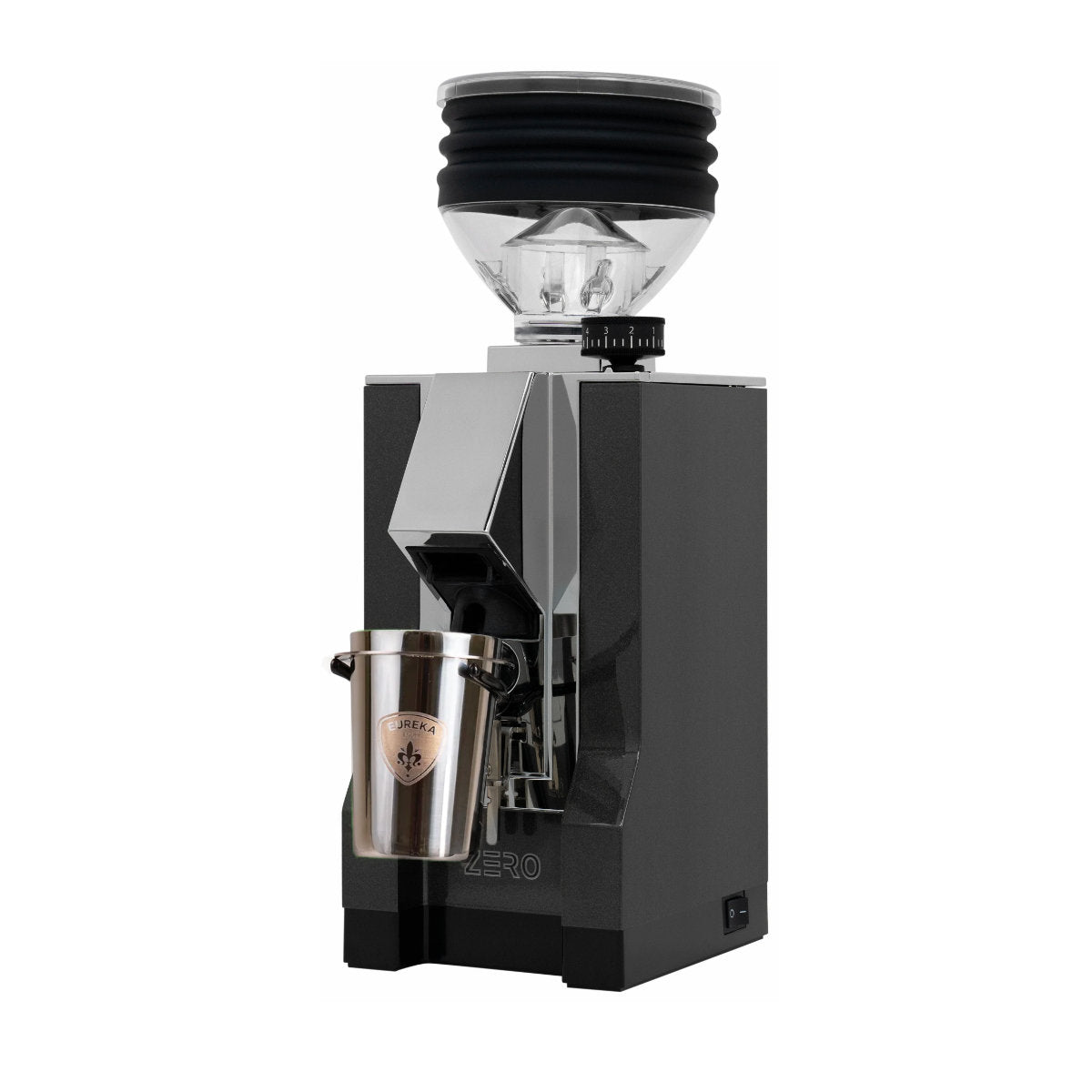 The Eureka Mignon Zero, an anthracite single-dose coffee grinder, features a sleek metallic design with angular lines. Its hopper and spout dispense ground coffee into its "Zero" labeled metal cup, perfect for espresso lovers. Currently backordered.