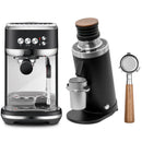 The Breville Black Friday Bundle includes the Bambino Plus Espresso Machine in Black Truffle, showcasing a modern design with stainless steel elements and black highlights, perfectly complemented by the DF64 Gen 2 Grinder in black. The grinder is distinguished by its wooden top, and the portafilter adds an elegant touch with its wooden handle.