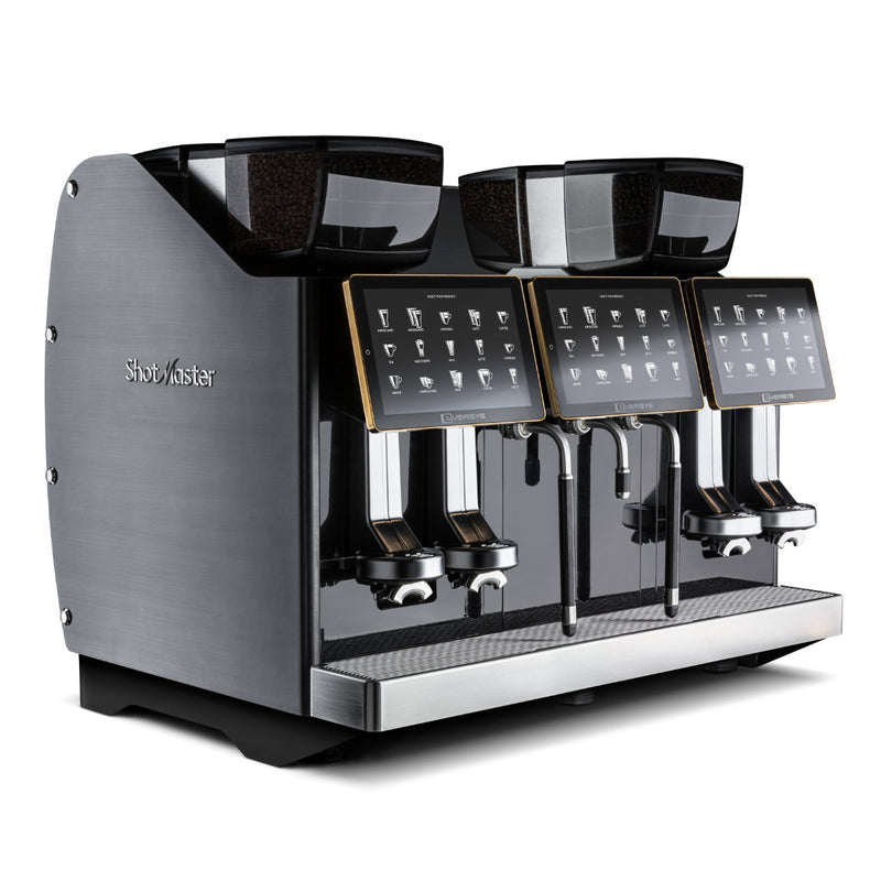 The Eversys Shotmaster 4 Group Head Steam Wand Pro Super Traditional Espresso Machine s-pro/ST (Charcoal) by Eversys is a sleek, modern espresso machine boasting four brewing heads, each with an intuitive touch screen interface. Constructed from durable stainless steel and elegant charcoal materials, this machine features a built-in milk module for perfect froth, integrated grinders at the top, and multiple dispensing spouts below for optimal convenience.