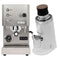 A Profitec Go stainless steel espresso machine, featuring buttons, knobs, and a steam wand, sits next to a sleek DF64 Gen 2 Grinder with DLC burrs in white, complete with a wooden lid and stainless steel receptacle.