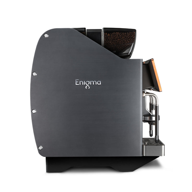 Side view of a sleek, modern espresso coffee machine labeled "Eversys Enigma 2 Group Head Steam Wand Super Traditional Espresso Machine E'4s/ST (Charcoal)." The machine features a matte charcoal finish with silver accents and a transparent hopper filled with coffee beans on top. A display screen is visible on the front, near the built-in coffee spouts and milk frothing wand.