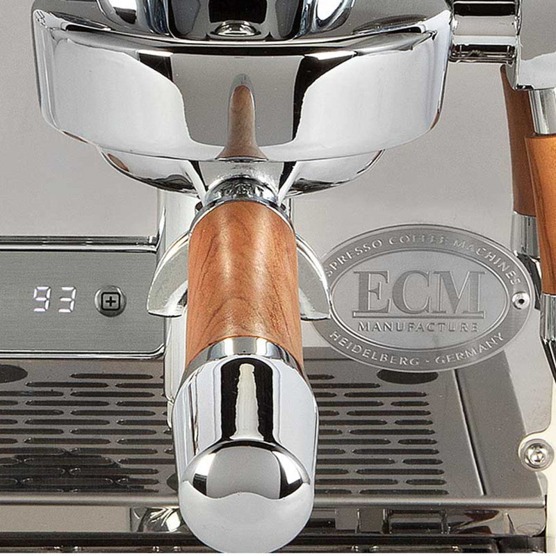 Close-up of the ECM Puristika Semi Automatic Espresso Machine in cream, showcasing a luxurious E61 group head with wooden handles. The digital display shows "93," indicating the precision of its PID controller. A sophisticated ECM plaque adorns the side, enhancing its sleek design.