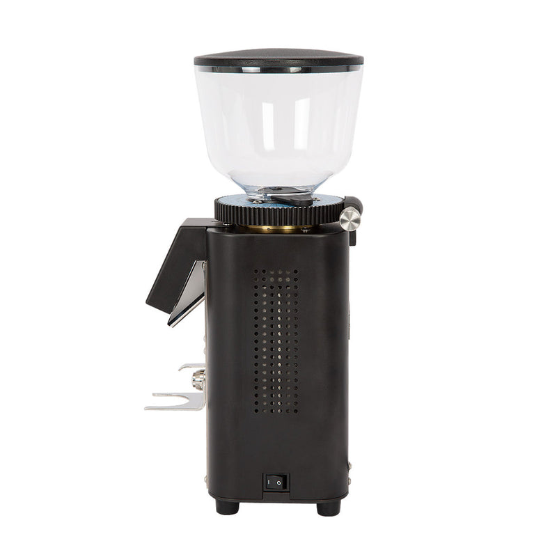 Side view of the Profitec Twist A54 Coffee Grinder features a transparent bean hopper atop its sleek design, with 54mm burrs for precision. It includes a stainless steel power switch at the base and a metal lever on the side for easy operation.