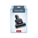 Packaging for the Miele Handy TurboBrush Vacuum Cleaner Attachment STB 101, showcasing an image of the compact, black accessory with its eco-friendly design on a light blue background.