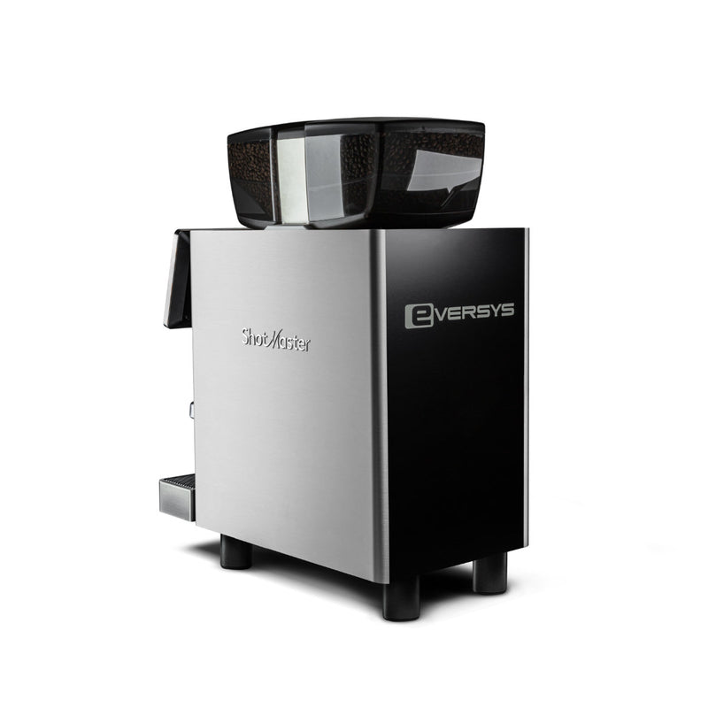 The Eversys Shotmaster 2 Group Head Coffee Compact Classic Espresso Machine in silver and black, featuring a transparent hopper filled with coffee beans on top. Ideal for high-volume environments, its sleek design showcases the Eversys logo prominently on the front and includes a small dispensing area on the side. The machine sits against a plain white background.