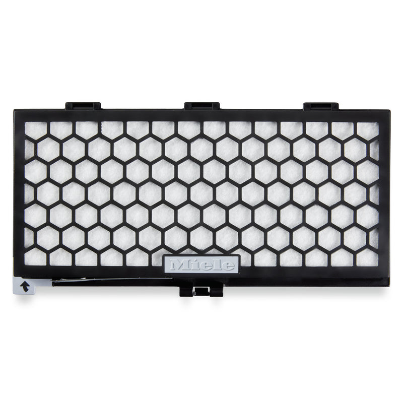 A rectangular filter encased in a black plastic frame with a honeycomb pattern, featuring a white filter material that includes a central "Miele" plaque. The Miele Active AirClean filter with TimeStrip SF-AA 30 efficiently controls odors and has an installation guide arrow located in the bottom left corner.