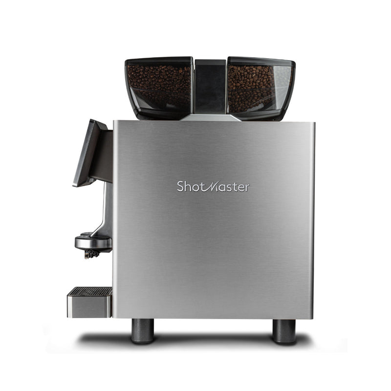 Introducing the Eversys Shotmaster 2 Group Head Coffee Compact Classic Espresso Machine c/Classic (Tempest), a fully automatic stainless steel espresso machine. This model features black compartments for coffee beans on top and combines sleek, modern design with high functionality, making it ideal for high-volume environments. The coffee spout and drip tray are conveniently located on the left side.