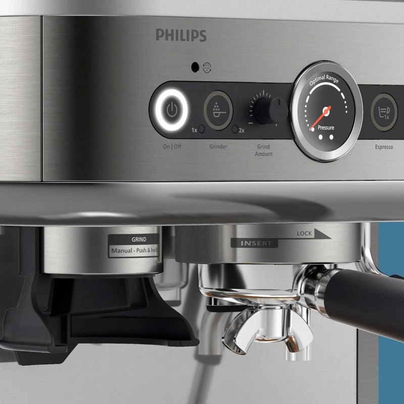 A close-up of a Philips Barista Brew Semi Automatic Espresso Machine PSA3228/01 (Silver) features control buttons, a pressure gauge, and a stainless steel portafilter. The silver machine with black accents includes power, grind, espresso settings, and a dual bean hopper for versatile brewing.