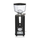 The ECM S-Automatik 64 Burr Grinder in anthracite features a contemporary design with a transparent bean hopper elegantly positioned on its streamlined, rectangular body. Accentuated by a silver dial, multiple buttons, and the distinctive ECM logo prominently displayed on the front, this on-demand grinder provides freshly ground coffee beans with both precision and style.