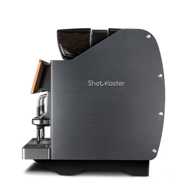 Side view of the sleek, modern Eversys Shotmaster 4 Group Head Steam Wand Pro Super Traditional Espresso Machine s-pro/ST (Charcoal) with a dark metallic finish. The machine showcases visible coffee beans at the top, a steam wand equipped with Everfoam for perfect frothing, and a coffee spout extending from the front left side, positioned over a drip tray.