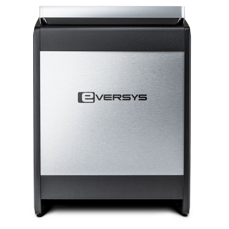 The Eversys Cameo Milk System Classic Espresso Machine C'2ms (Tempest) by Eversys boasts a sleek and modern aesthetic with a silver and black finish. Its front panel features the Eversys logo on a brushed metal surface. The machine is rectangular with rounded edges and includes an advanced milk system, ensuring barista-quality performance.