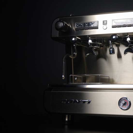 A sleek, black espresso machine from the Conti CC100 range, featuring a single group head and equipped with a pressure gauge for precise coffee extraction, rests on a dark surface. The brand name "Conti" graces the front panel, contrasting with the plain, dark background.