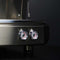 Close-up of a Conti CC100 1 Group Espresso Machine CONCC1001TCN (Black), showcasing two round gauges with red and black markings. The appliance's sleek, stainless steel finish stands out against a dark background, emphasizing its modern design ideal for precise coffee extraction.