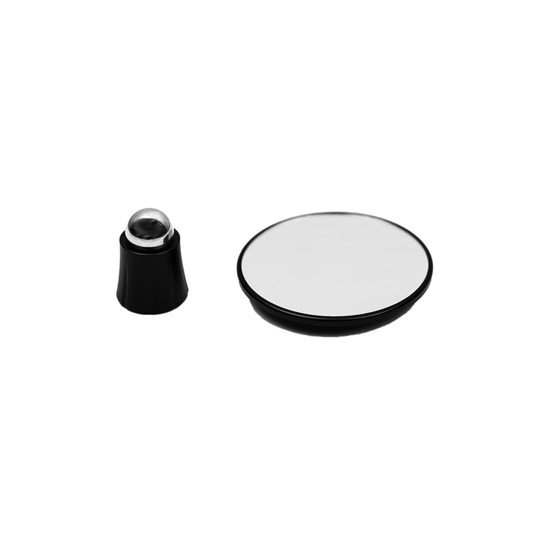 A sleek, black round base featuring a spherical stainless steel ball roller sits beside the HCS Espresso Shot Mirror, which has a circular design and a black rim. Both items are showcased on a simple white background.