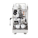 An ECM Classika II PID Espresso Machine in stainless steel with an E61 group head and two white cups on the drip tray. The machine features various knobs and buttons, a steam wand on the left side, and a pressure gauge. Additional white cups are stored on the top of this single boiler machine.