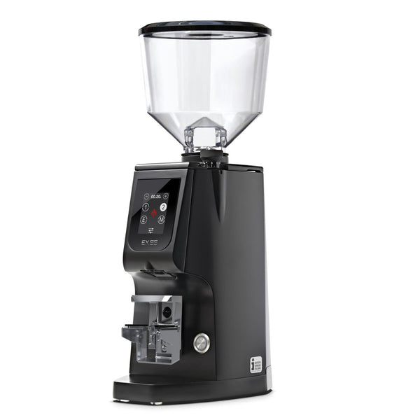 Introducing the Eureka Atom Excellence 65 Grinder in matte black, this coffee grinder combines sleek design with advanced technology. It features a transparent bean hopper on top and 65mm Burr Grinder technology. The front panel is equipped with digital controls and a compact display screen, while its angled design and chrome accents offer a modern and professional look.