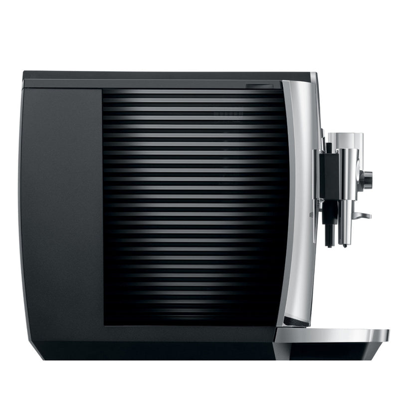 The Jura E8 Chrome Automatic Coffee Machine 15371 OPEN BOX (4033) by Jura is a sleek, modern espresso machine in black with a side profile view emphasizing its ribbed design. It features a stainless steel spout on the right and a drip tray at the bottom. The overall design is compact and minimalist, utilizing Pulse Extraction Process (P.E.P.) for optimal coffee extraction.