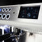 Close-up of the Conti MC Ultima Espresso Machine's digital display and control panel in black. The screen displays gauges for steam and pump, complemented by nearby circular buttons. Boasting adjustable temperature settings, a portafilter is situated below the panel to ensure perfect brewing precision.