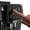 A finger presses the touchscreen control panel of the sleek, black DeLonghi Magnifica Start Super Automatic Espresso Machine ECAM22022B, highlighting its integrated grinding technology. The screen presents options such as espresso, coffee drinks, and americano, along with icons for steam and additional functions—perfect for achieving a flawless LatteCrema Hot.