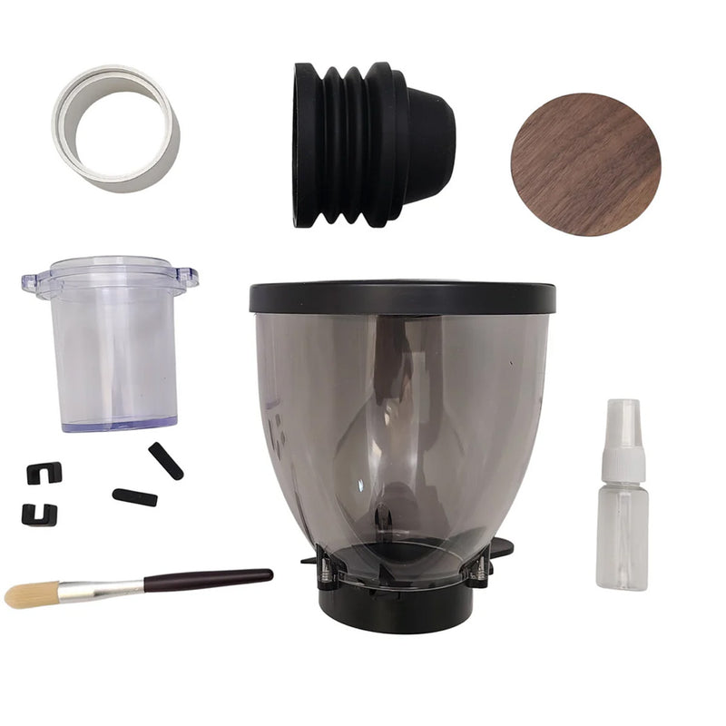 A photo displaying the various parts and accessories for the DF Grinders DF83 ELR Single Dose Coffee Grinder With DLC Burrs (White) features a clear plastic hopper, a black rubber seal, a wood lid, a brush, a small spray bottle, a clear plastic cup, 83mm DLC burrs, and several small black clips.