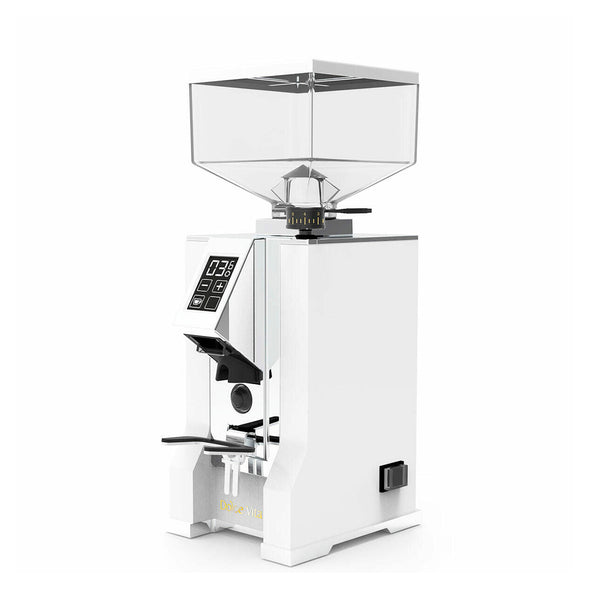 A sleek, modern white coffee grinder with a transparent hopper on top. The Eureka Oro Mignon Dolce Vita (White) from the brand Eureka features a digital display with various buttons for settings and controls, equipped with Silent Technology and Pure Diamond Burrs. The brand name "Eureka" is visible near the base.