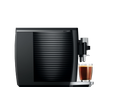 Side view of a sleek JURA E8 Piano Black Automatic Coffee Machine 15648 (Latest Version) with a ribbed design, dispensing a fresh cup of barista-quality coffee into a clear glass. The machine boasts minimalist aesthetics, and the glass showcases the distinct layers of coffee and crema.