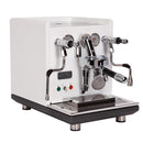 The ECM Synchronika Espresso Machine - Dual Boiler w/ PID and Flow Control (Special Edition White) by ECM is a sleek, white dual boiler machine with multiple metallic levers, knobs, and dials on the front panel. It features an E61 Group Head, a double spout for dispensing espresso, a frothing wand, pressure gauges, and indicator lights at the bottom. The base is stainless steel.