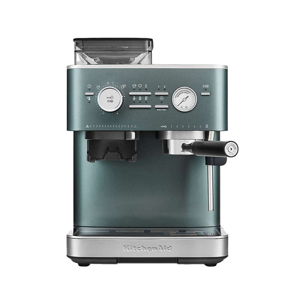 A sleek KitchenAid Semi Automatic Espresso Machine with Burr Grinder in juniper (KES6551JP). It features a teal blue-green color with a silver base, various buttons, knobs, and dials for settings, a coffee bean hopper on top, and a portafilter and steam wand at the front. The integrated Burr Grinder ensures precise grounds for your perfect brew.