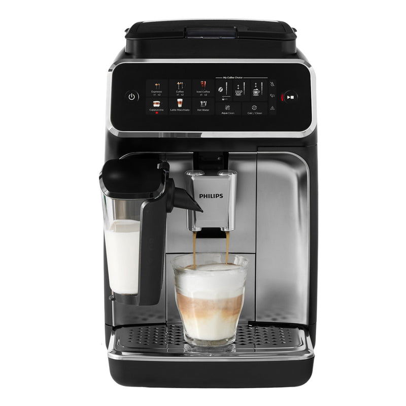 The Philips 3300 LatteGo Super Automatic Espresso, Cappuccino, & Latte Macchiato Machine with SilentBrew EP3347/90 (Black Chrome) is currently crafting a latte using its advanced LatteGo system. A glass of perfectly layered coffee and milk rests under the touch screen interface at the top, which showcases a variety of coffee options. The scene is completed by the elegant process of milk frothing.