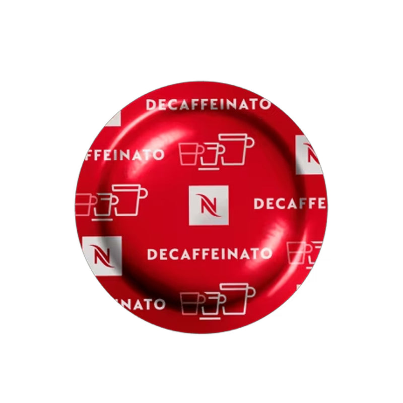 A red Nespresso Decaffeinato Professional Capsule, featuring the word "DECAFFEINATO" and the Nespresso logo printed repeatedly across its surface. The design also includes small white icons of coffee cups. This decaffeinated coffee offers an aromatic intensity and delivers a full-bodied cup for your enjoyment.