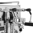 A close-up view of the polished Pro 600 espresso machine by Profitec, showcasing its chrome-plated finish and multiple handles with black knobs. Its intricate design, featuring the Dual Boiler system, Quick Steam technology, and E61 Group Head with PID Temperature Control, gleams under light, highlighting the detailed engineering and sleek aesthetic.