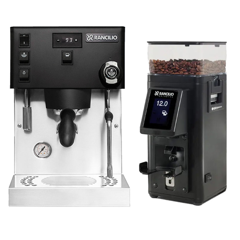 The Rancilio Silvia Pro X Dual Boiler and Racillio Stile Grinder Bundle (Black) includes an espresso machine equipped with a steam wand and a coffee grinder, side by side. It offers precision control via its digital display and multiple buttons, while the grinder features a transparent hopper filled with coffee beans and an electronic interface for convenient adjustments.